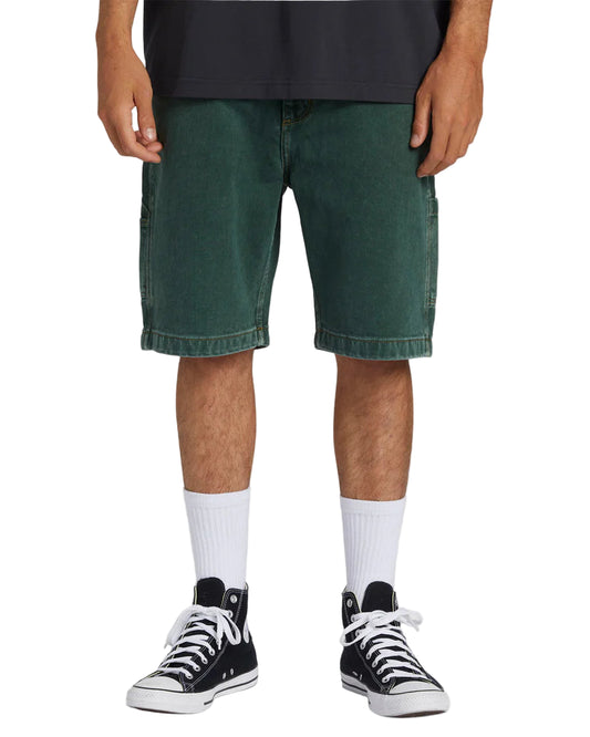 A pair of Billabong Bad Dog men's shorts in green color, featuring a relaxed fit with pockets and embroidered branding on the back.