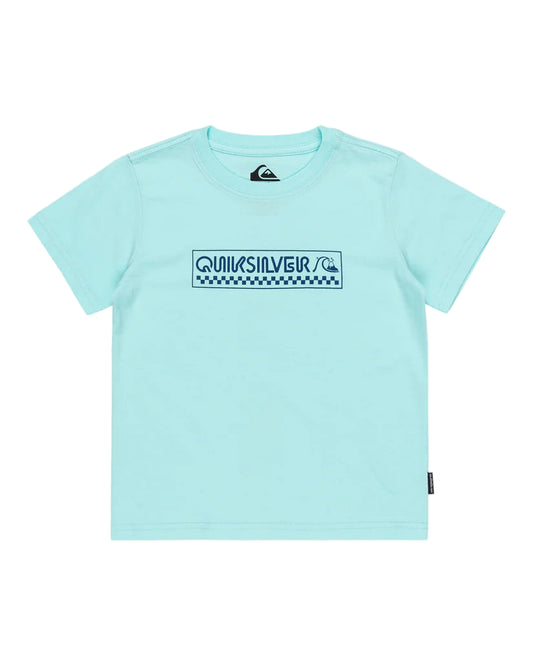 A light blue Quiksilver kids t-shirt with a crew neck and short sleeves, featuring a bubble check pattern on the front.